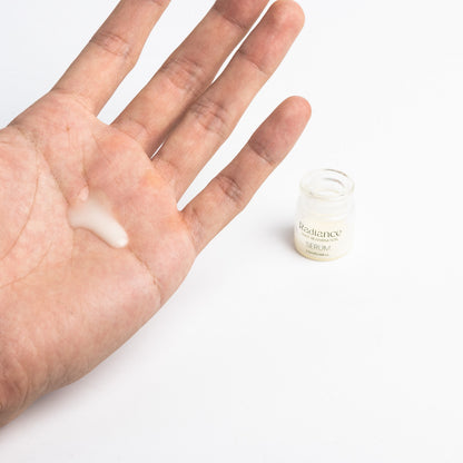 Refining Serum in the palm, open jar beside it
