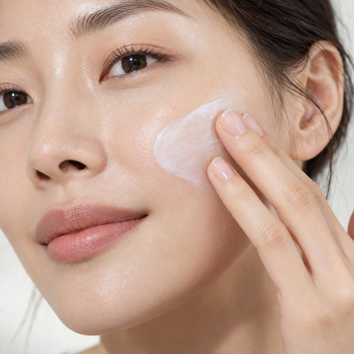 Repair Set + Cleanser step 03: applying Repair Protector on the cheek